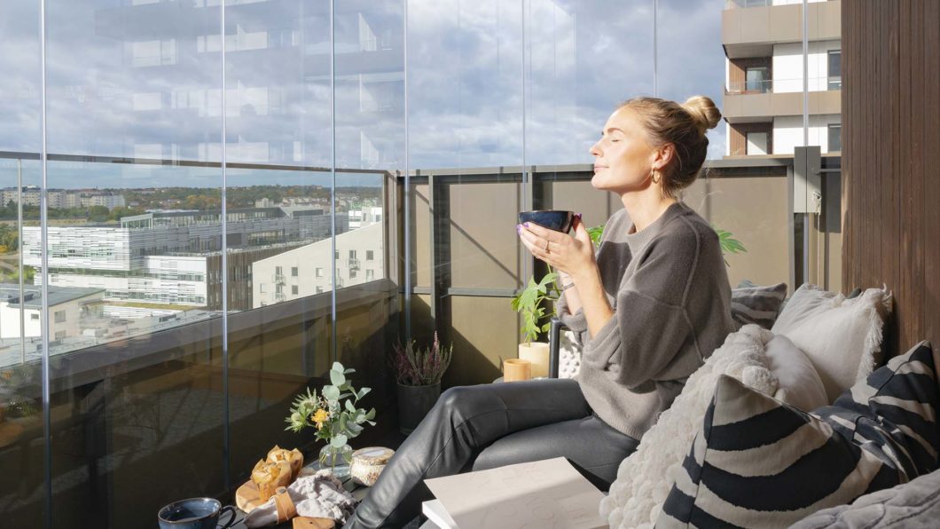 Women enjoying her Lumon balcony glazing