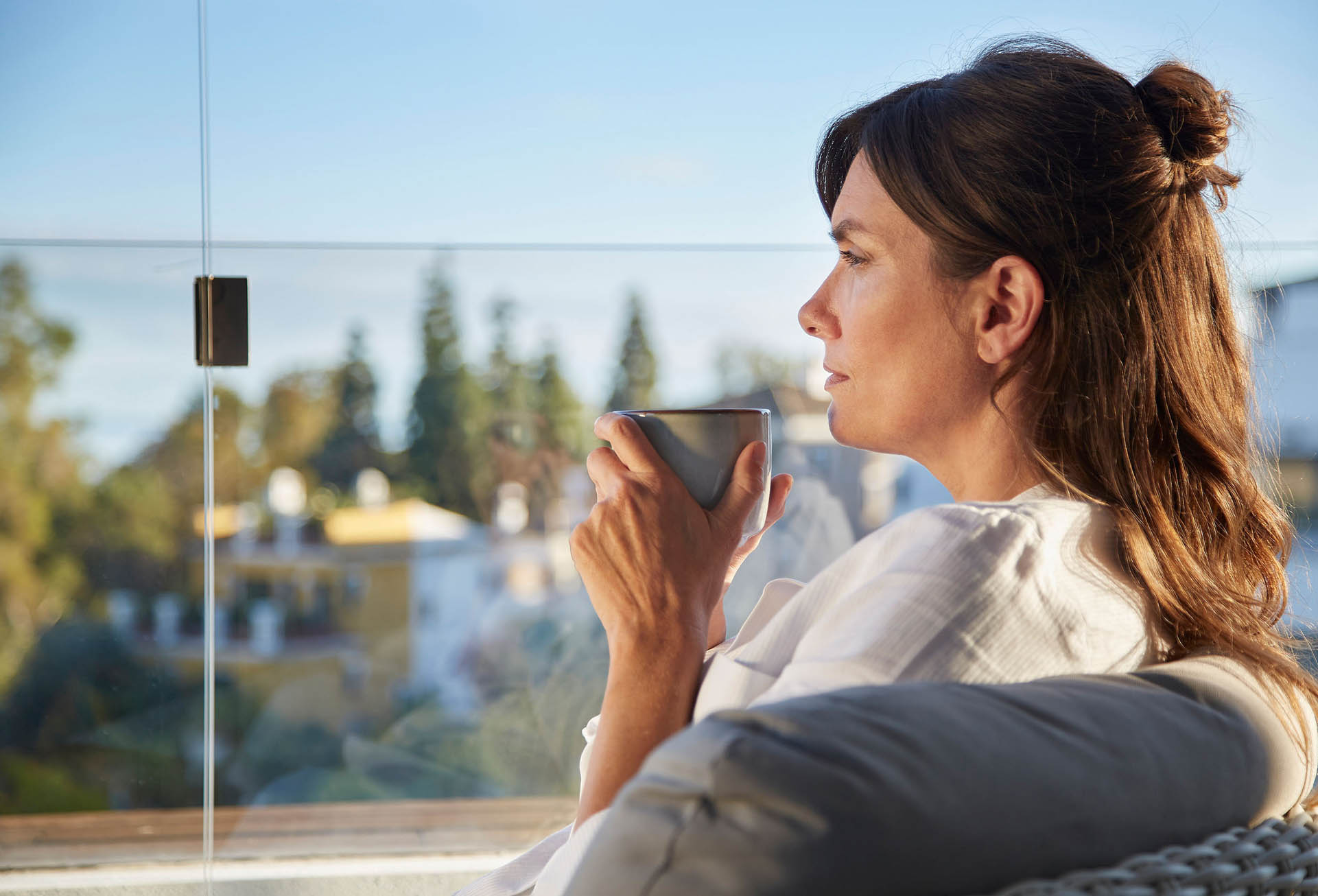 Lady enjoying a view from Lumon balcony glazing 