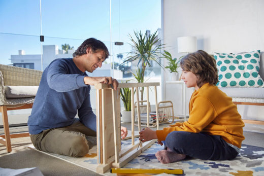 Father and child playing in Lumon balcony enclosure