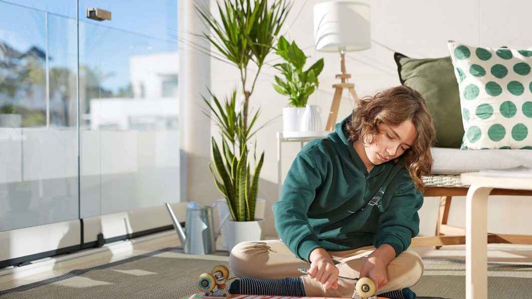 A young boy repairing his skateboard at his house in Greater Toronto