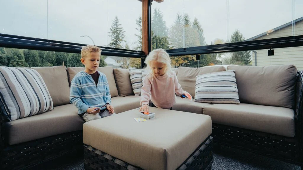 Two kids playing in a sunroom of their home in Greater Vancouver
